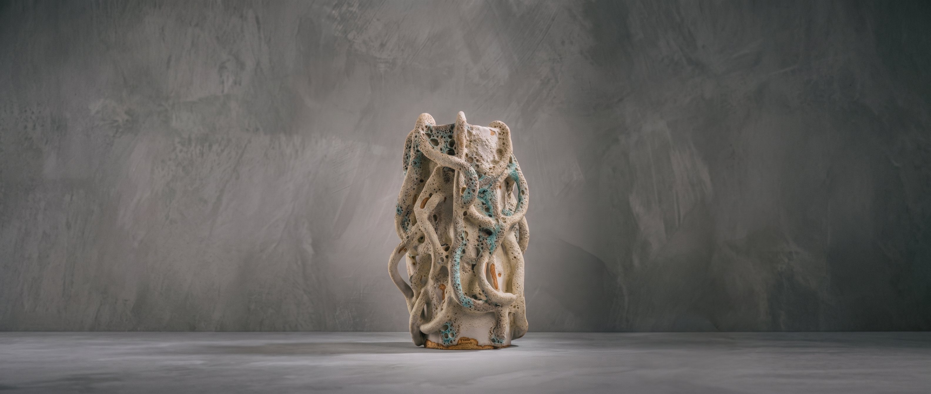 Hand-built ceramic vessel by Paola Kassabian with intertwined coral-like coils and sea-green glaze